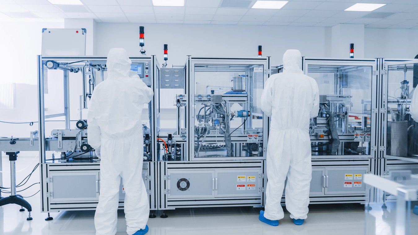 Manufacturing Laboratory where Scientists in Protective Coverall's Work with Industrial High Precision 3D Printing Machinery. Manufacturing Pharmaceutical / Technological / Industrial Products.